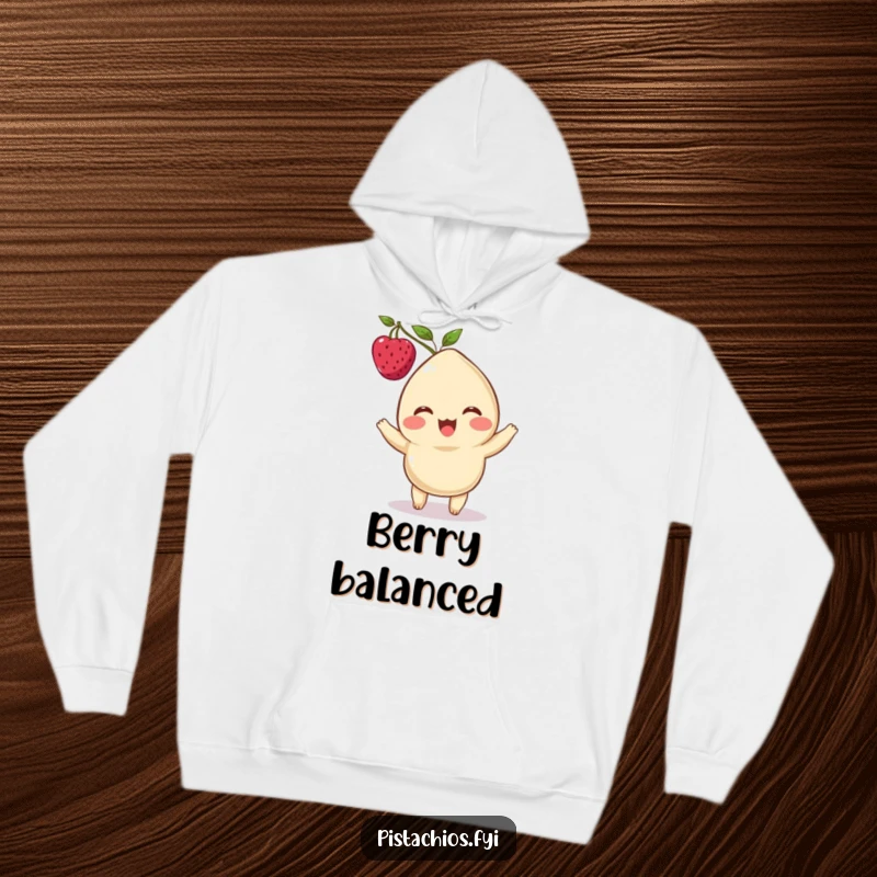 Funny hoodie featuring a delighted cashew character with a berry balanced on its head, offering warmth and whimsical style.
